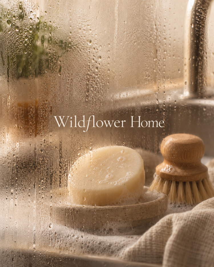 Wildflower Home collection, round solid dish soap with bamboo brush by a softly lit kitchen sink