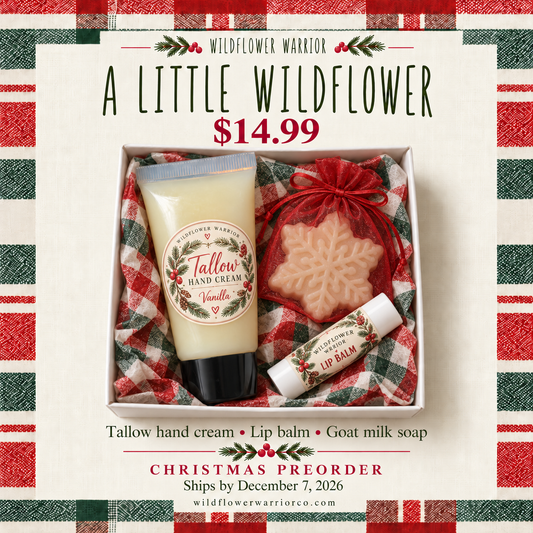 A Little Wildflower Christmas gift box with tallow hand cream, white lip balm and snowflake goat milk soap in red mesh bag and plaid tissue